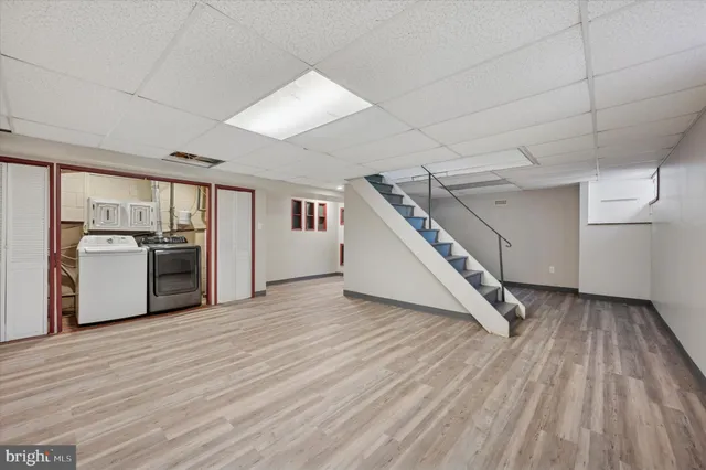 a view of a kitchen with a sink and a refrigerator