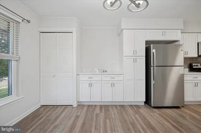 a view of a kitchen with a refrigerator and a window