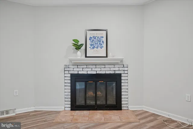 a living room with a fireplace and a wooden floor
