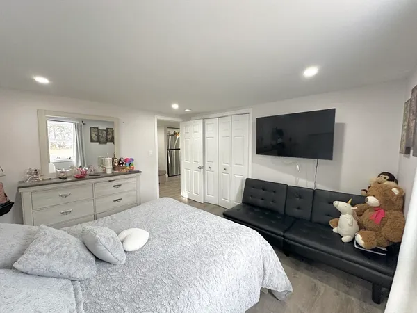 a bedroom with a bed and a flat screen television