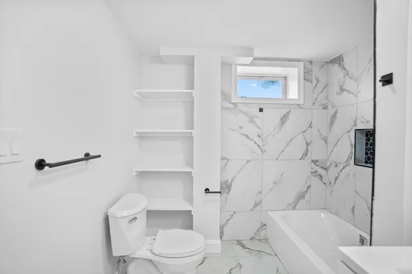 a bathroom with a toilet and shower