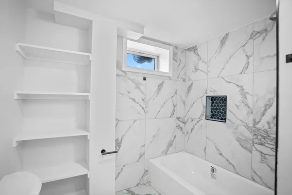 a bathroom with a bathtub and a shower