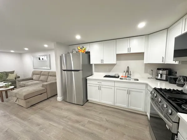 a kitchen with refrigerator and cabinets