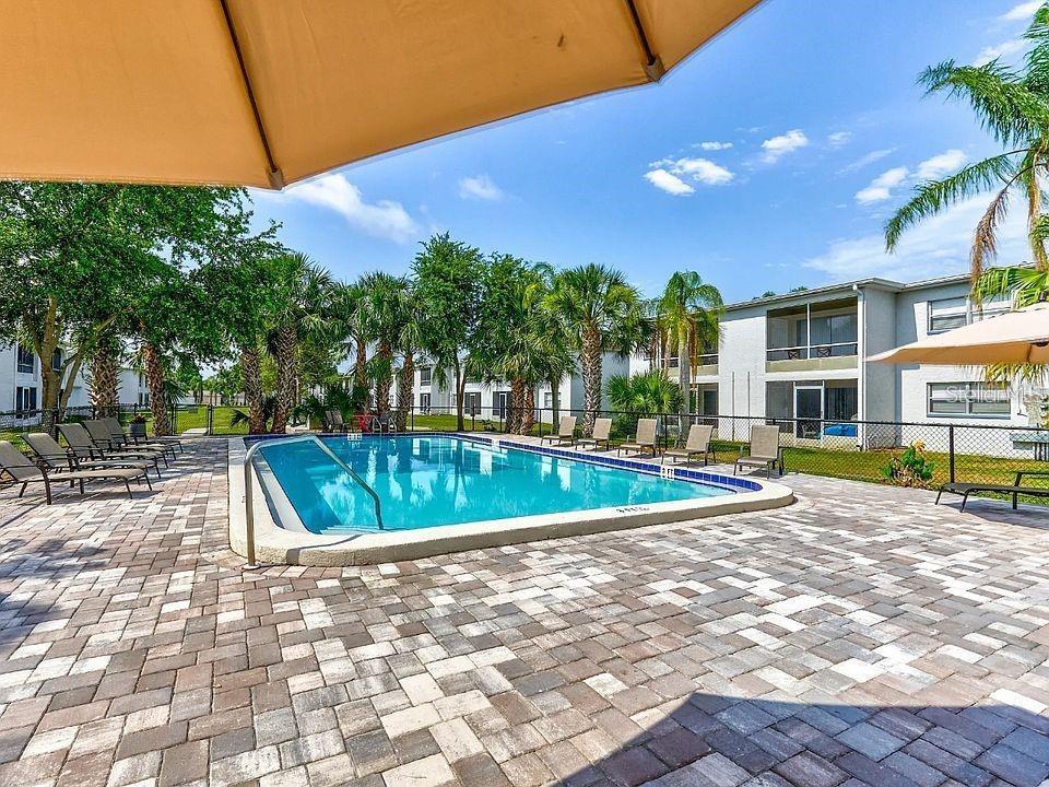 9911 Aquarius Drive, Unit 4 Port Richey, FL 34668 - Photo 19 of 26 a view of a swimming pool with a patio