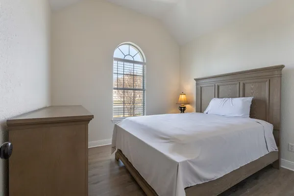 a bedroom with a bed and window