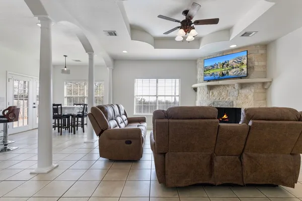 a living room with furniture and a fireplace