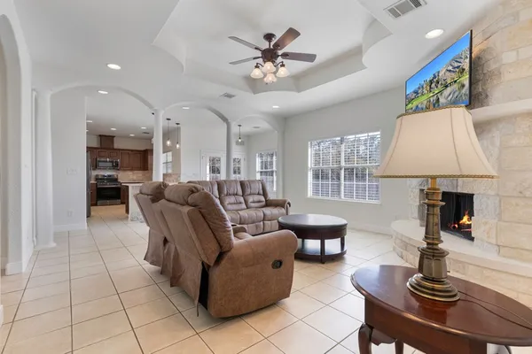 a living room with furniture a table and a fireplace
