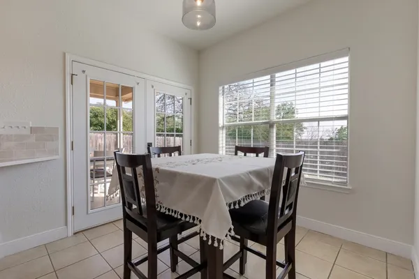 a view of a dining room with furniture and a window