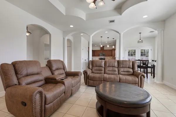 a living room with furniture and a chandelier