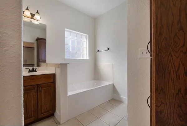 a bathroom with a bathtub and a sink