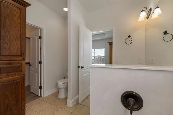 a bathroom with a toilet a sink and a mirror