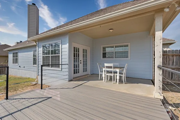 a view of a porch with wooden floor and a floor to ceiling window