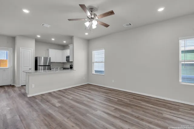 a view of kitchen with cabinets stainless steel appliances and window
