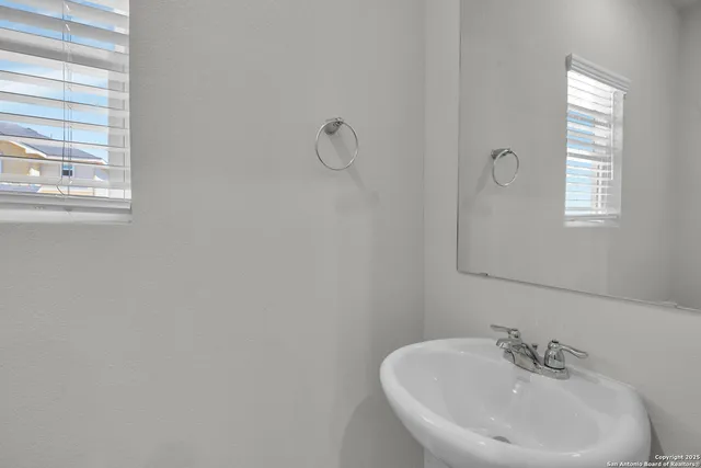 a bathroom with a sink and a window