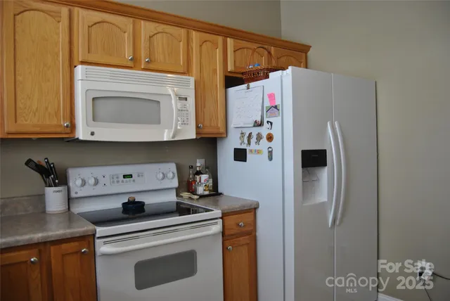 a white refrigerator freezer sitting inside of a kitchen
