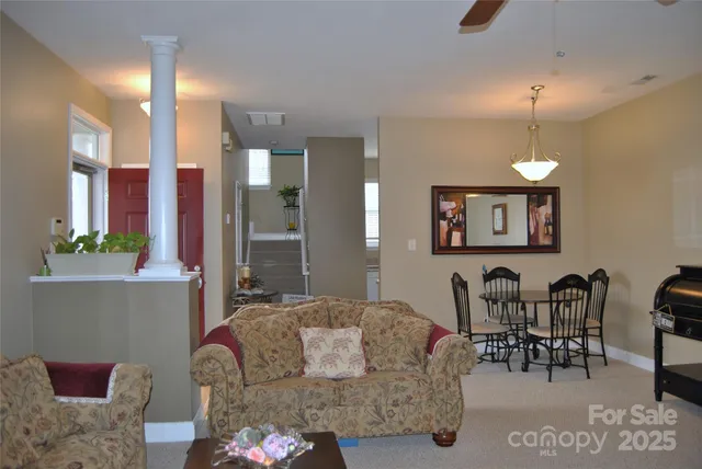 a living room with furniture and a chandelier