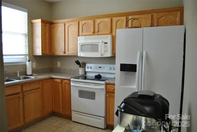 a kitchen with a refrigerator stove and white cabinets