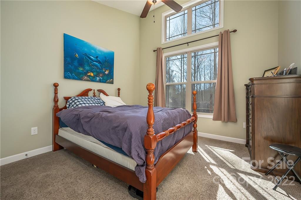 103 Christopher Road Tryon, NC 28782 - Photo 16 of 45 a bedroom with a bed lamp on desk and a window
