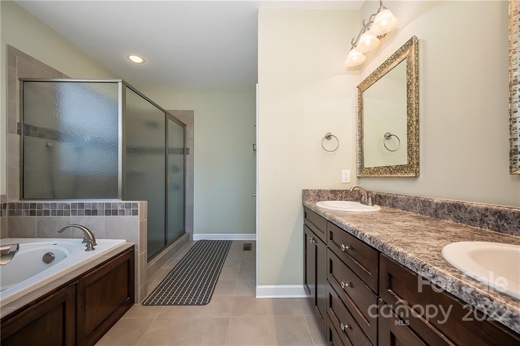 103 Christopher Road Tryon, NC 28782 - Photo 20 of 45 a spacious bathroom with a granite countertop double vanity sink and a mirror
