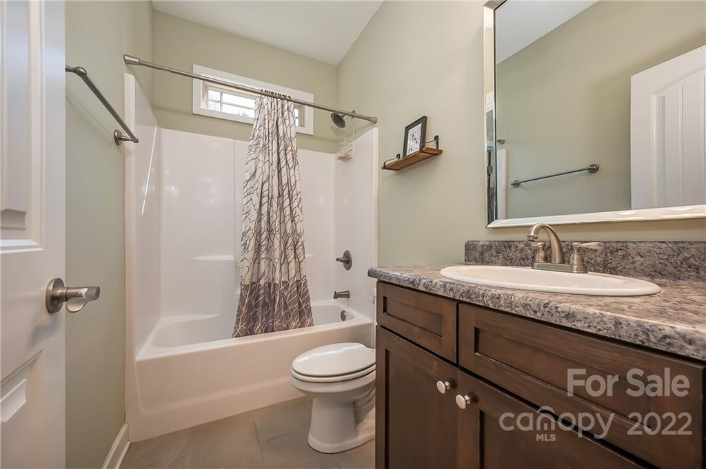 103 Christopher Road Tryon, NC 28782 - Photo 25 of 45 a bathroom with a granite countertop sink a toilet and shower