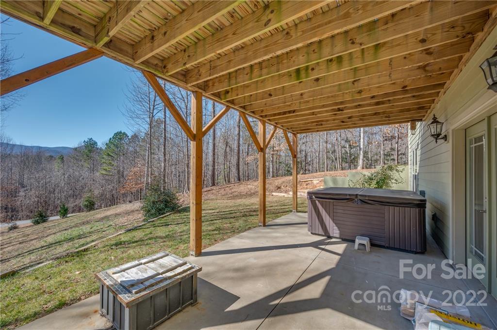 103 Christopher Road Tryon, NC 28782 - Photo 28 of 45 a backyard of a house with yard and outdoor seating