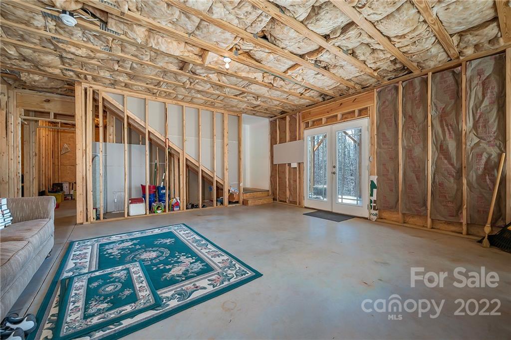 103 Christopher Road Tryon, NC 28782 - Photo 31 of 45 a view of an empty room with wooden floor and stairs