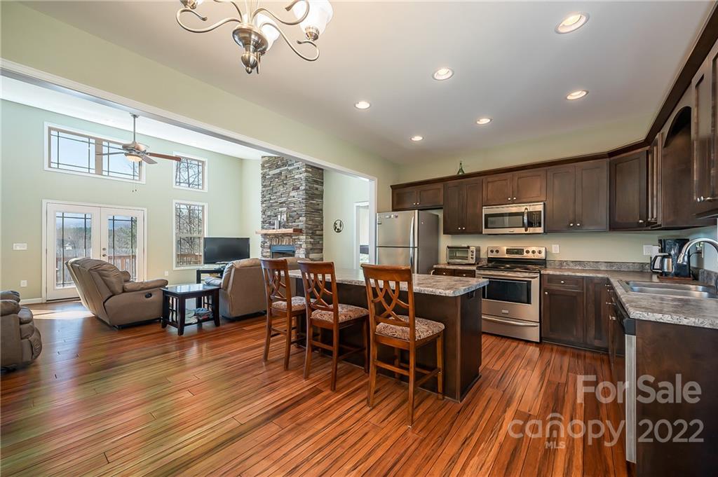103 Christopher Road Tryon, NC 28782 - Photo 4 of 45 a living room with stainless steel appliances granite countertop furniture wooden floor and view kitchen