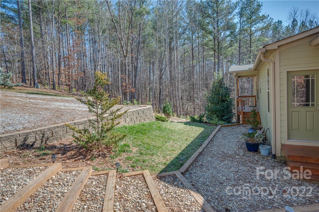 103 Christopher Road Tryon, NC 28782 - Photo 42 of 45 a view of a backyard with plants and large trees