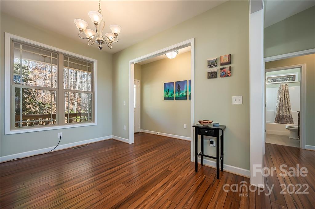 103 Christopher Road Tryon, NC 28782 - Photo 9 of 45 a view of a livingroom with wooden floor and a chandelier