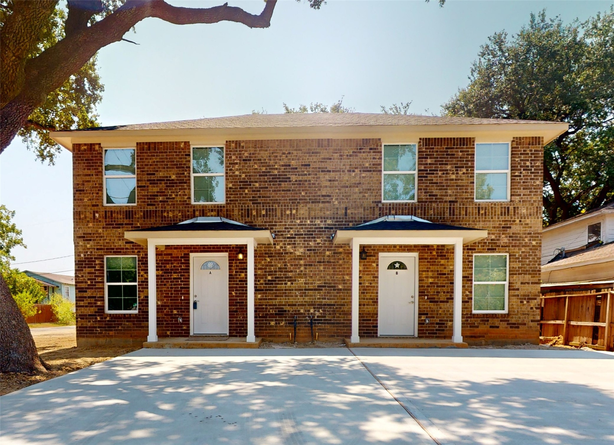 front view of a brick house with a large windows
