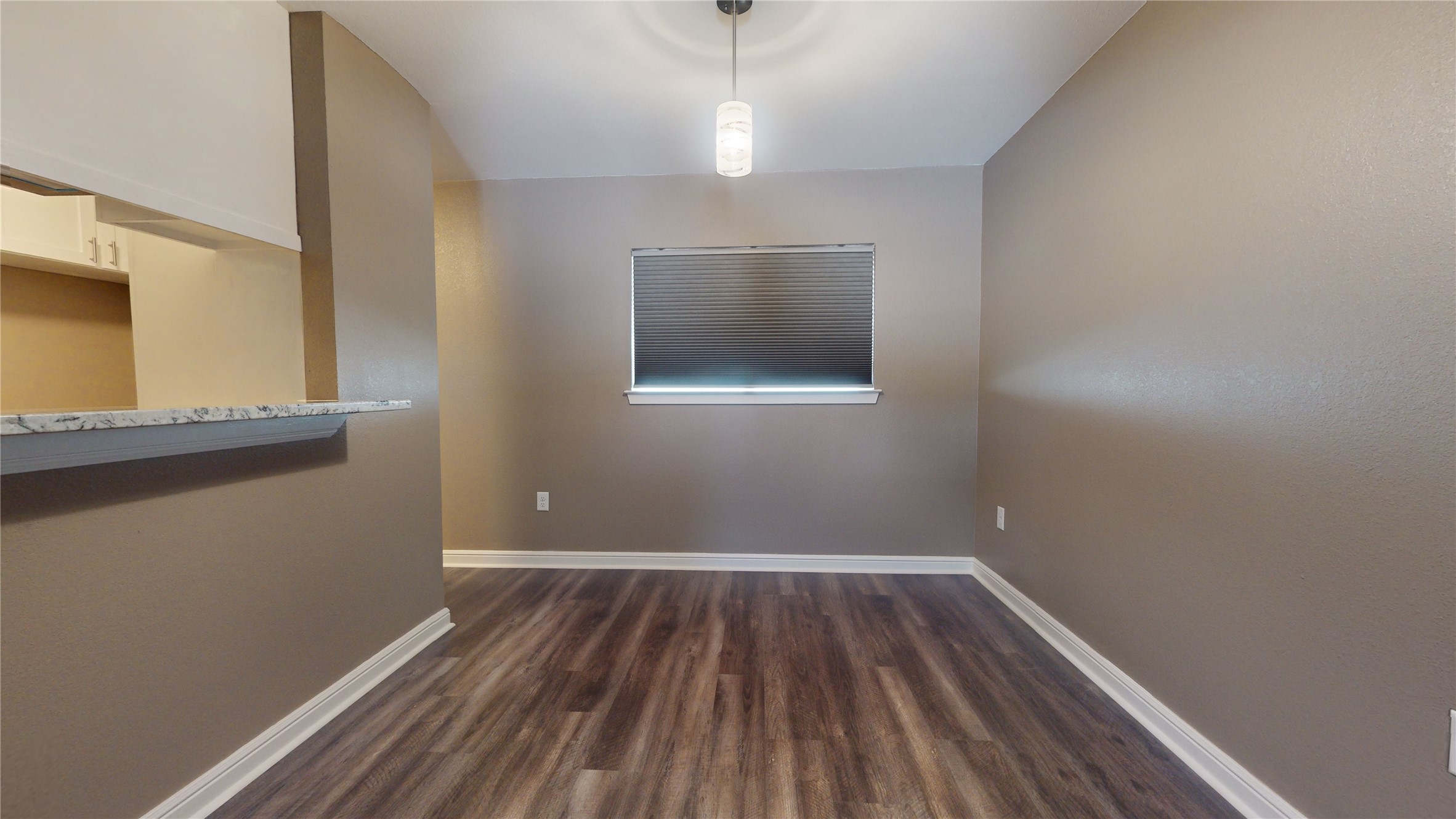 302 Georgia Street, Unit AB South Houston, TX 77587 - Photo 6 of 25 a view of an empty room with wooden floor and a window