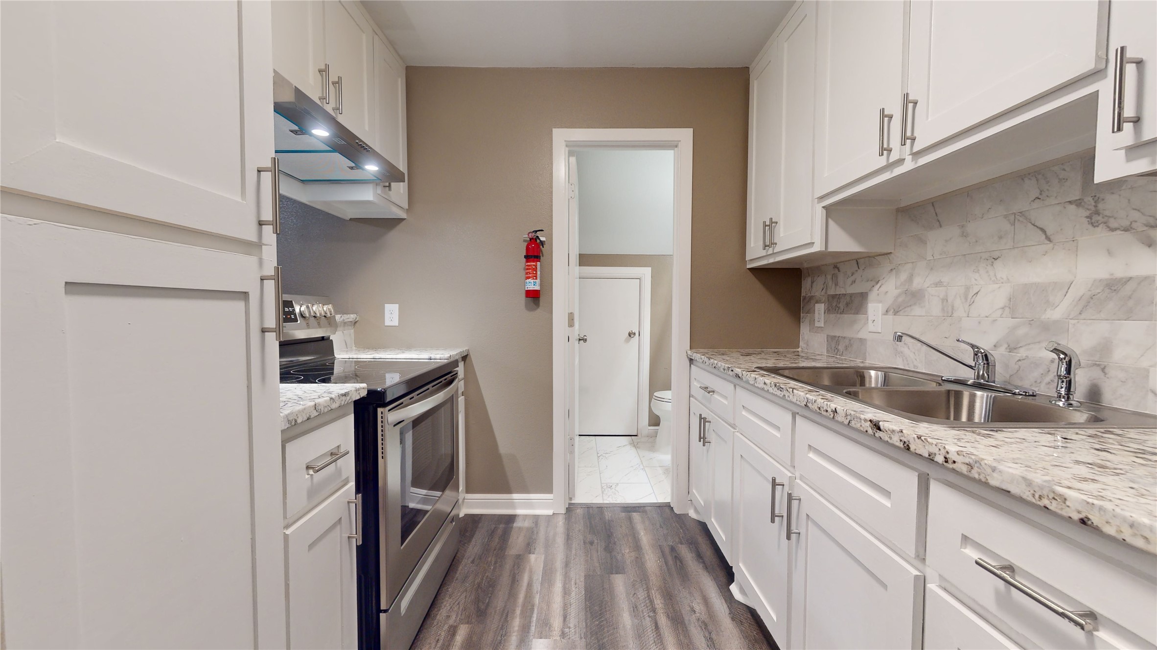 302 Georgia Street, Unit AB South Houston, TX 77587 - Photo 8 of 25 a kitchen with granite countertop a sink stove and refrigerator