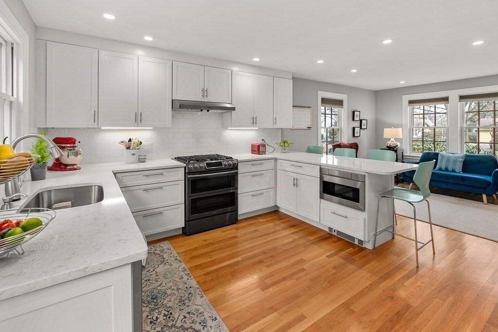 29 Louise Road Belmont, MA 02478 - Photo 7 of 17 a kitchen with a sink white cabinets and white appliances