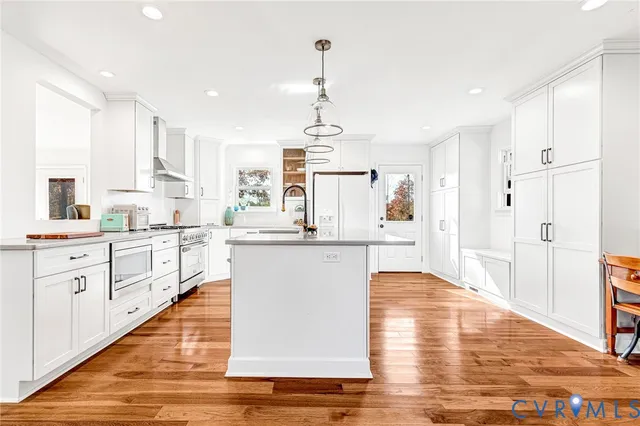 a kitchen with white cabinets and white appliances