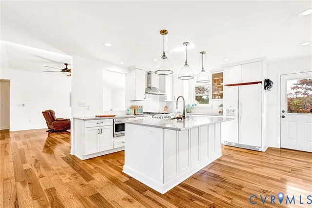 a kitchen with stainless steel appliances granite countertop a sink stove and cabinets