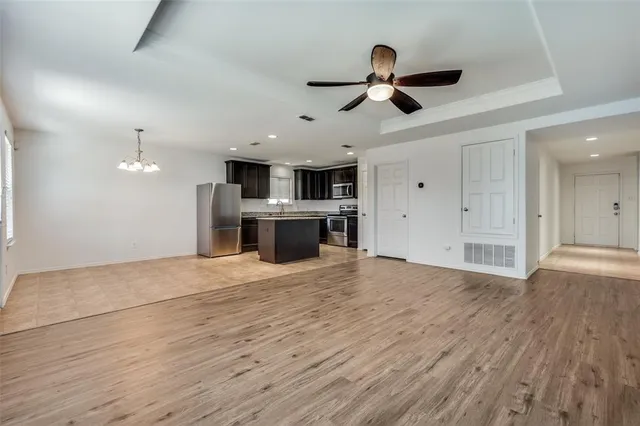 a view of empty room with wooden floor and window