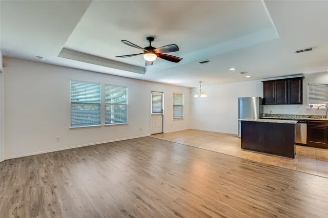 a view of kitchen with microwave and wooden floor