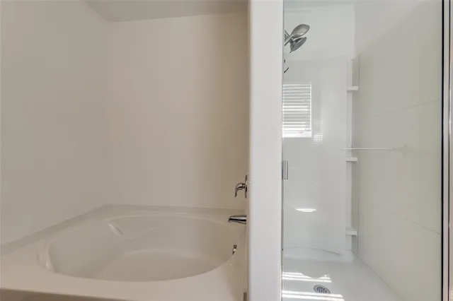 a white bath tub sitting next to a white sink