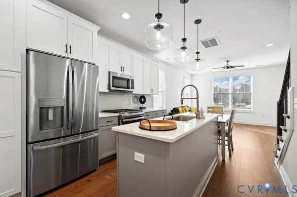 a kitchen with a refrigerator a sink and cabinets