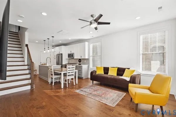 a living room with furniture and kitchen view