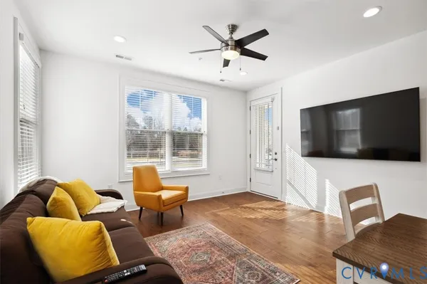 a kitchen with stainless steel appliances kitchen island granite countertop a stove a sink and a refrigerator