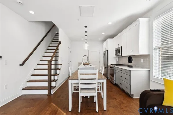 a kitchen with sink stove and refrigerator
