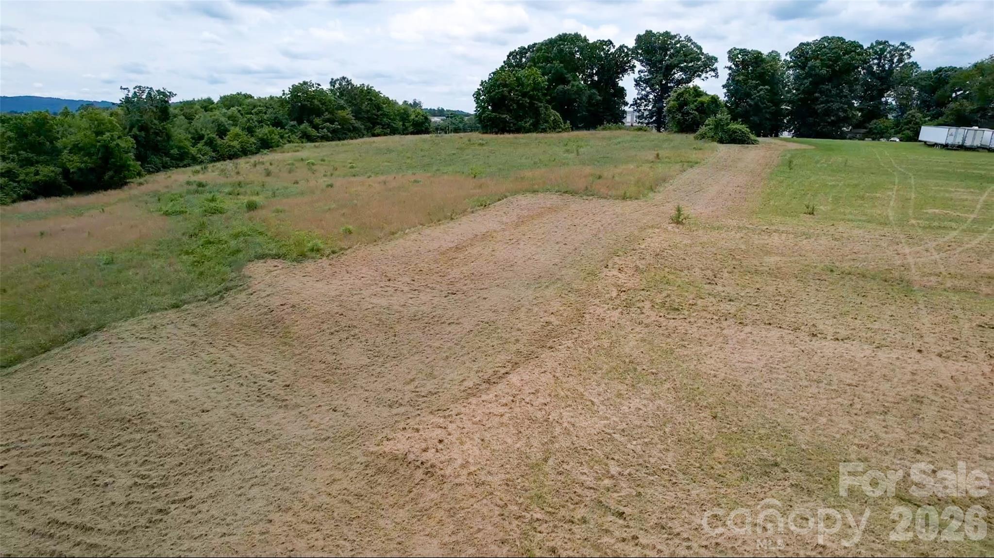 412 McMurray Road Flat Rock, NC 28731 - Photo 11 of 14 a view of a field with trees in the background