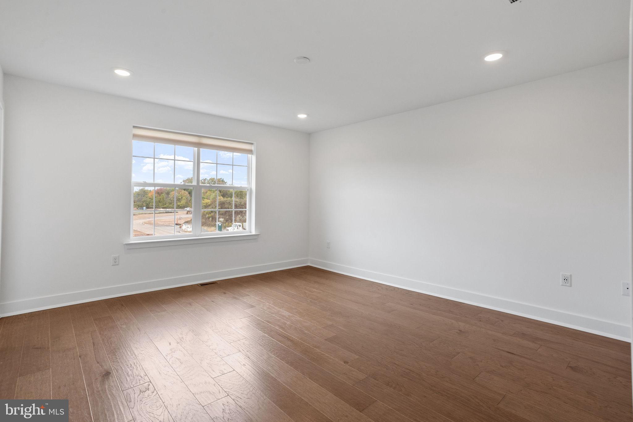 142 ADA Hightower Avenue Pennington, NJ 08534 - Photo 20 of 46 an empty room with wooden floor and windows