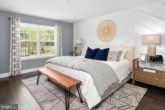 a bedroom with a bed lamp and a large window with outer view