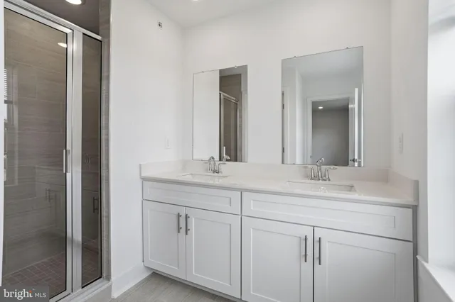 a bathroom with a double vanity sink and mirror