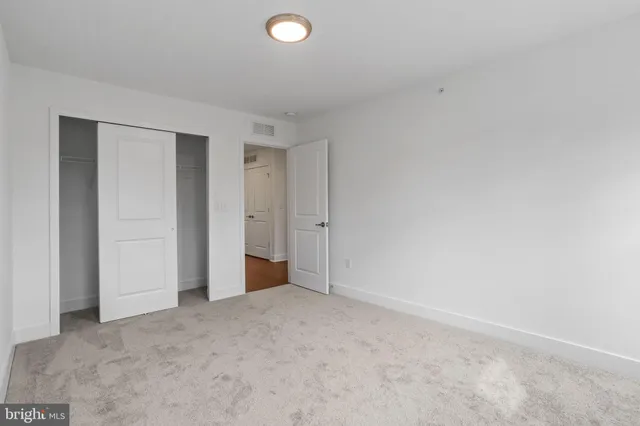 an empty room with closet area
