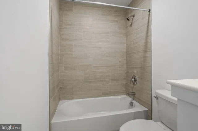 a bathroom with a bathtub and a toilet