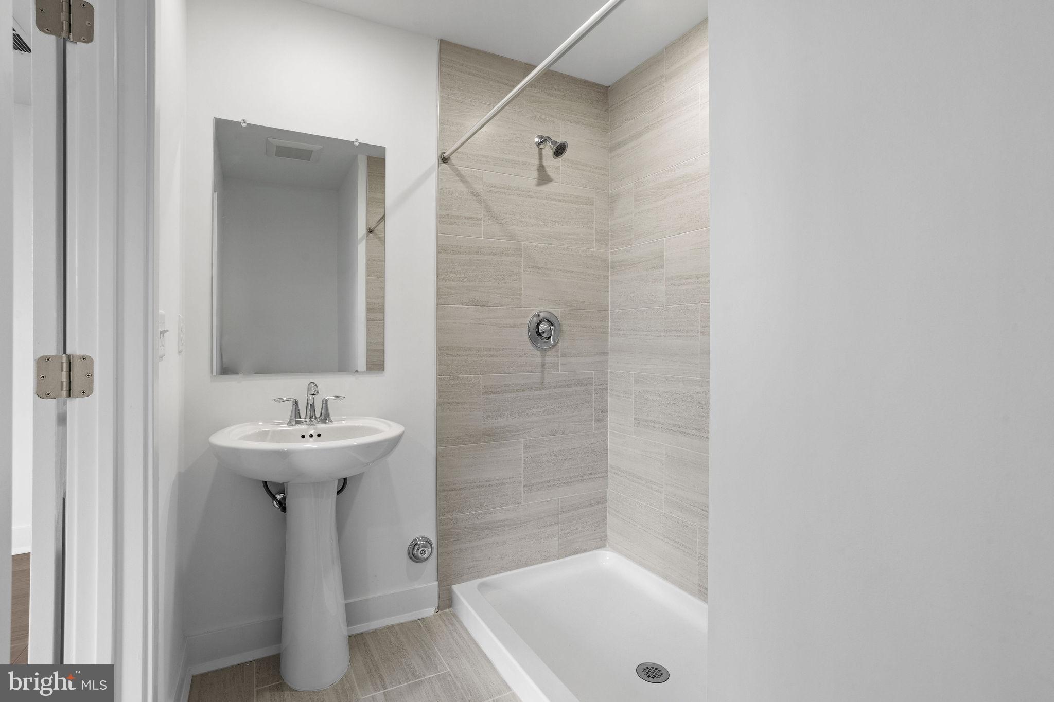 142 ADA Hightower Avenue Pennington, NJ 08534 - Photo 38 of 46 a bathroom with a sink a toilet and shower