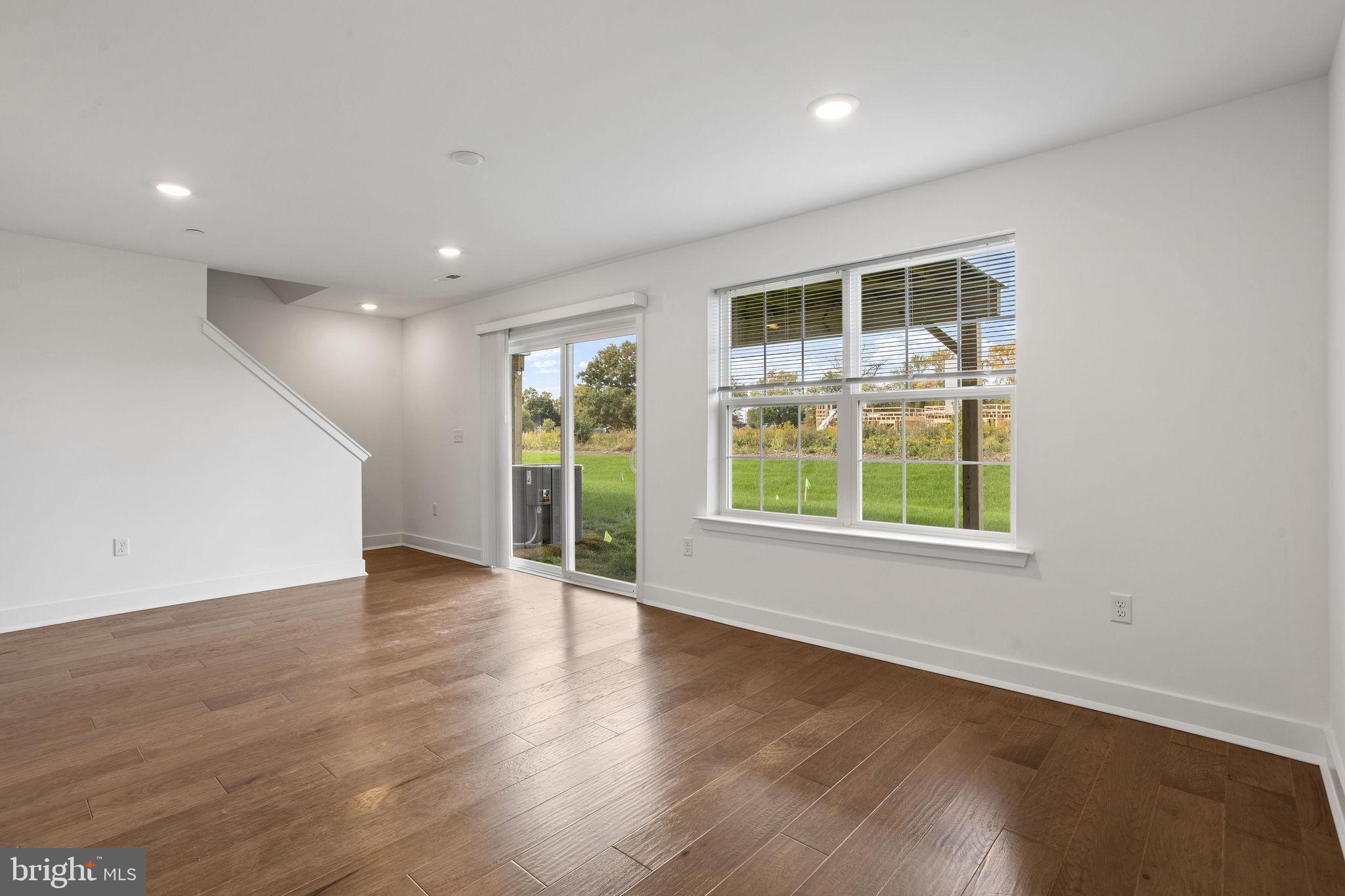 142 ADA Hightower Avenue Pennington, NJ 08534 - Photo 39 of 46 an empty room with wooden floor and windows